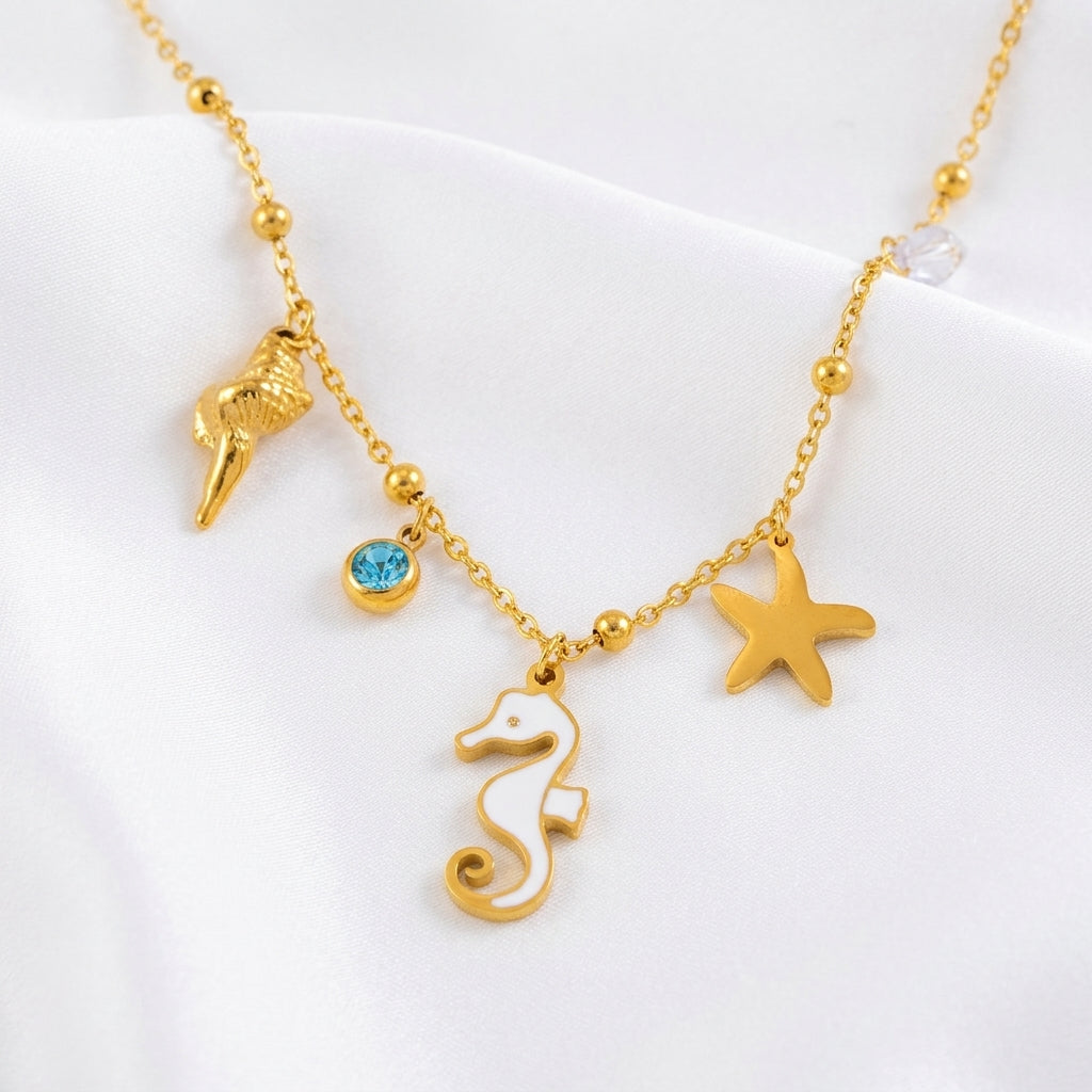Bracelet cheville charmes marins gros plan – hippocampe coquillage cristal bleu acier doré